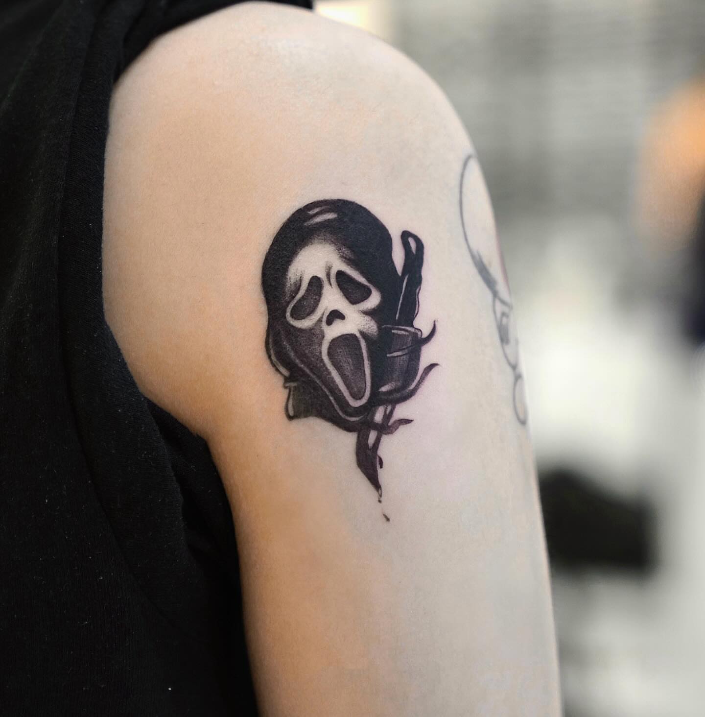 Scream mask black and grey tattoo on the shoulder by David H.