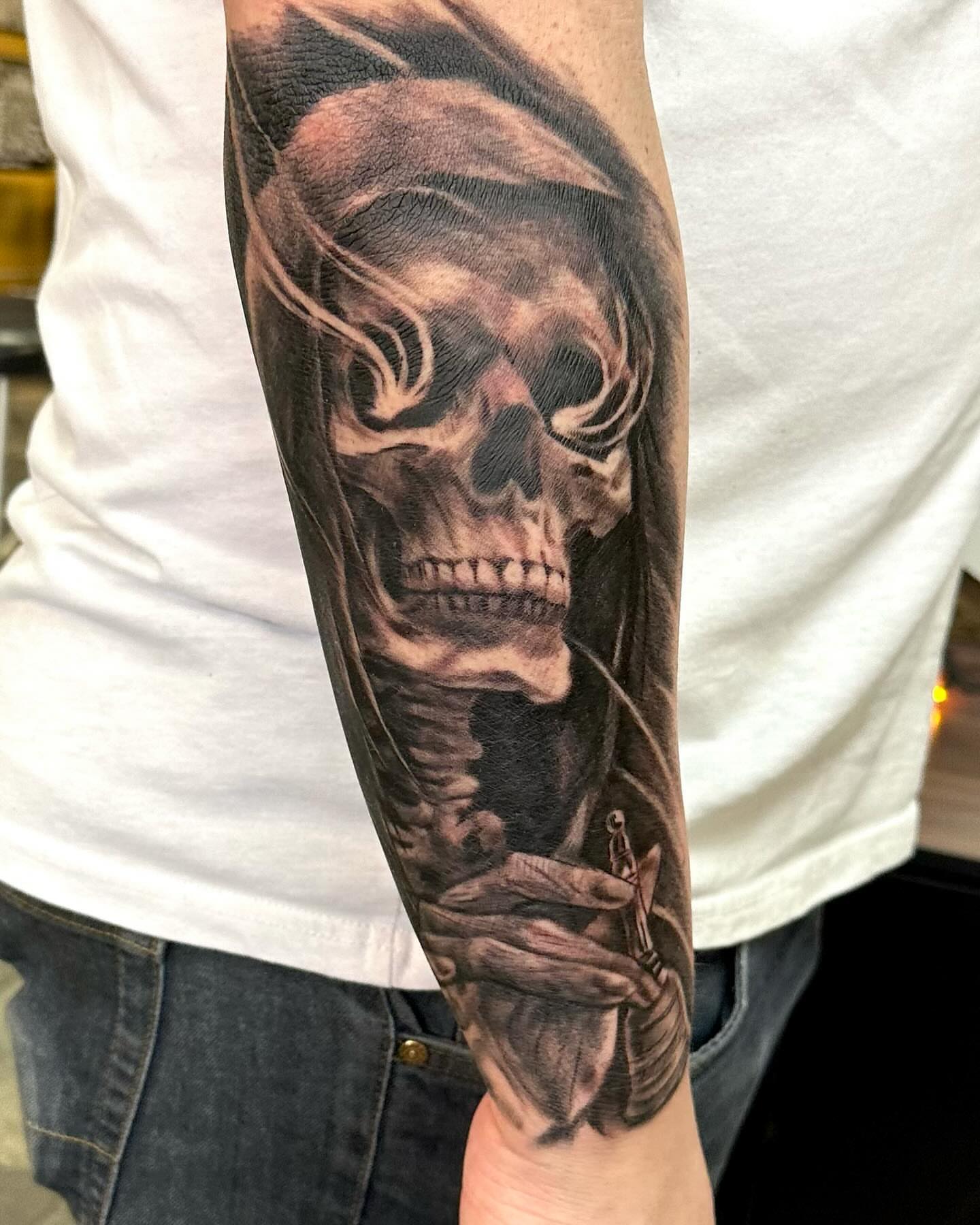Skull realism tattoo on the forearm by Comfy Chris Fettig