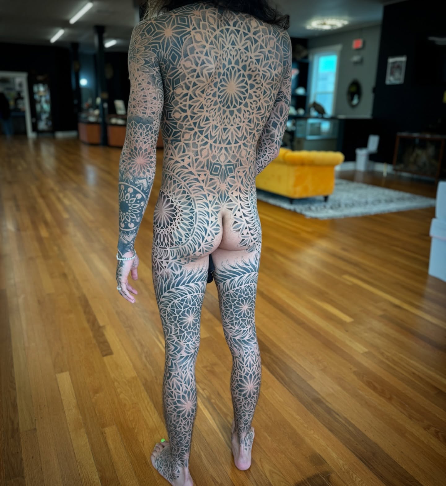 Full-body mandala geometric tattoo on the back by Paul Schnell