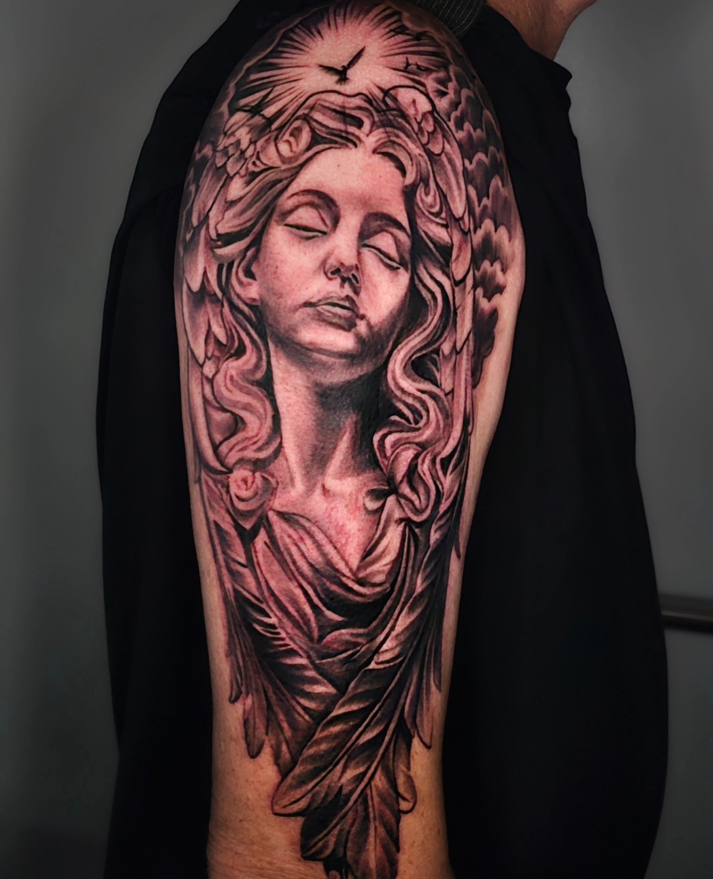 Angel realism tattoo on the forearm by Christian Mulvey