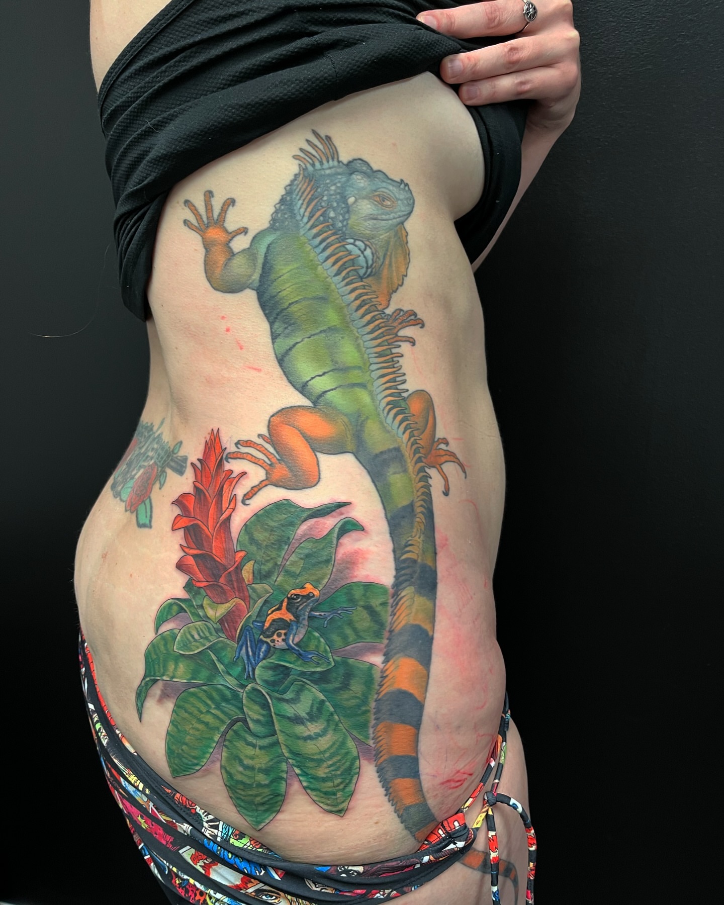 Iguana and tropical plants realism tattoo on the torso by Angelique Sanders, Tellico Plains, Tennessee