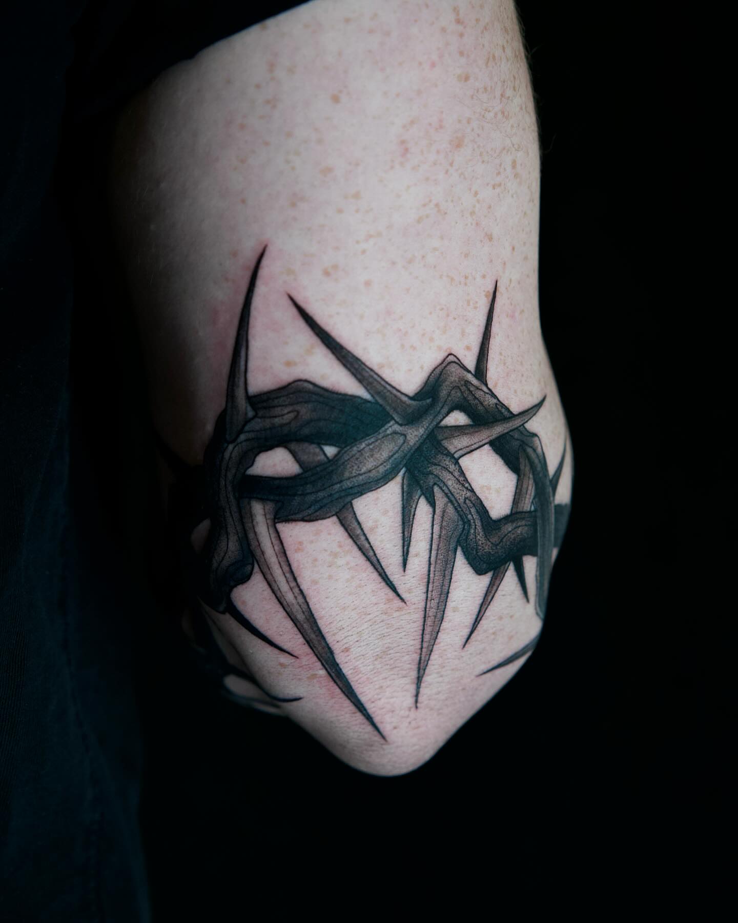 Crown of thorns black and grey tattoo on the forearm by Amber