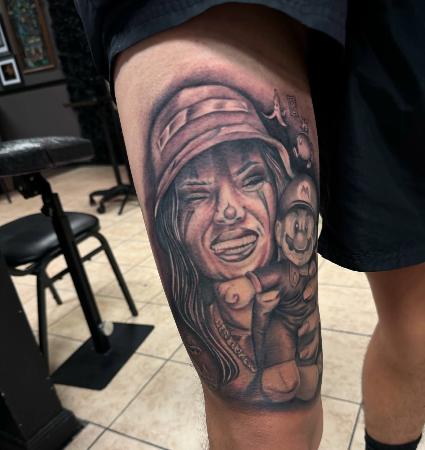 Woman crying with child realism tattoo on the thigh by Tattoo Artist