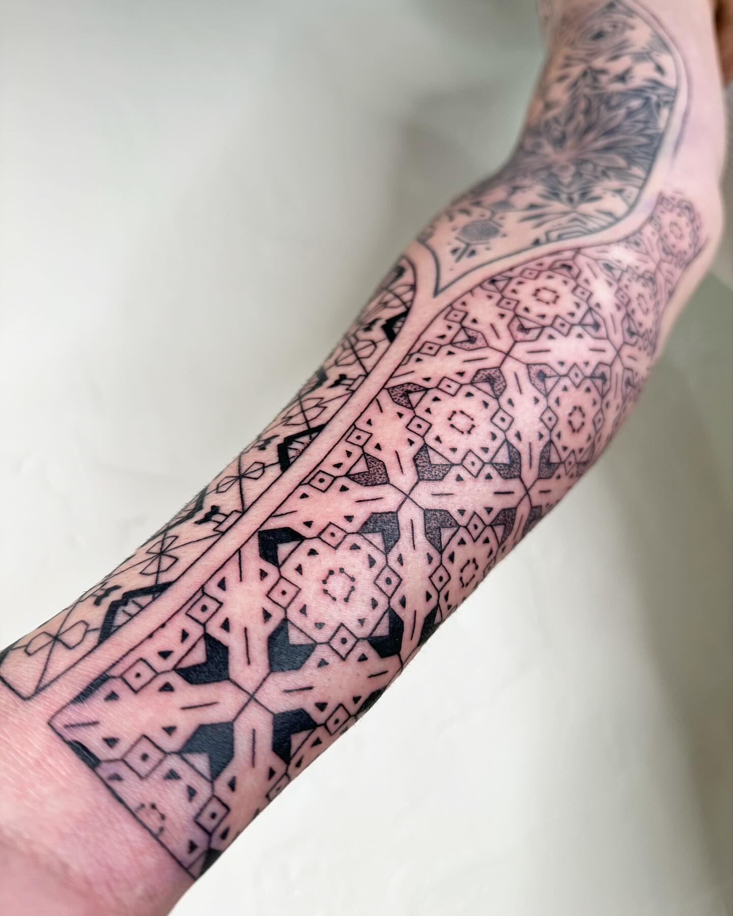 Geometric pattern geometric tattoo on the forearm by Ian Spencer