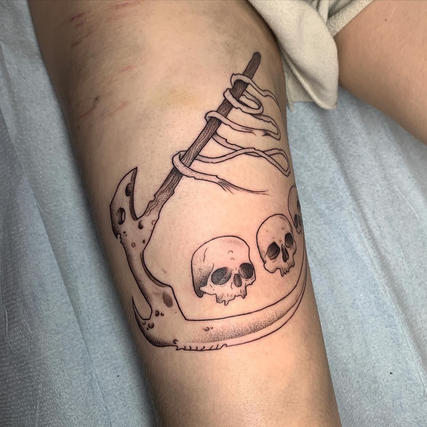 Anchor with skulls black and grey tattoo on the forearm by ⓣⓞⓡⓘ, Bangor, Maine