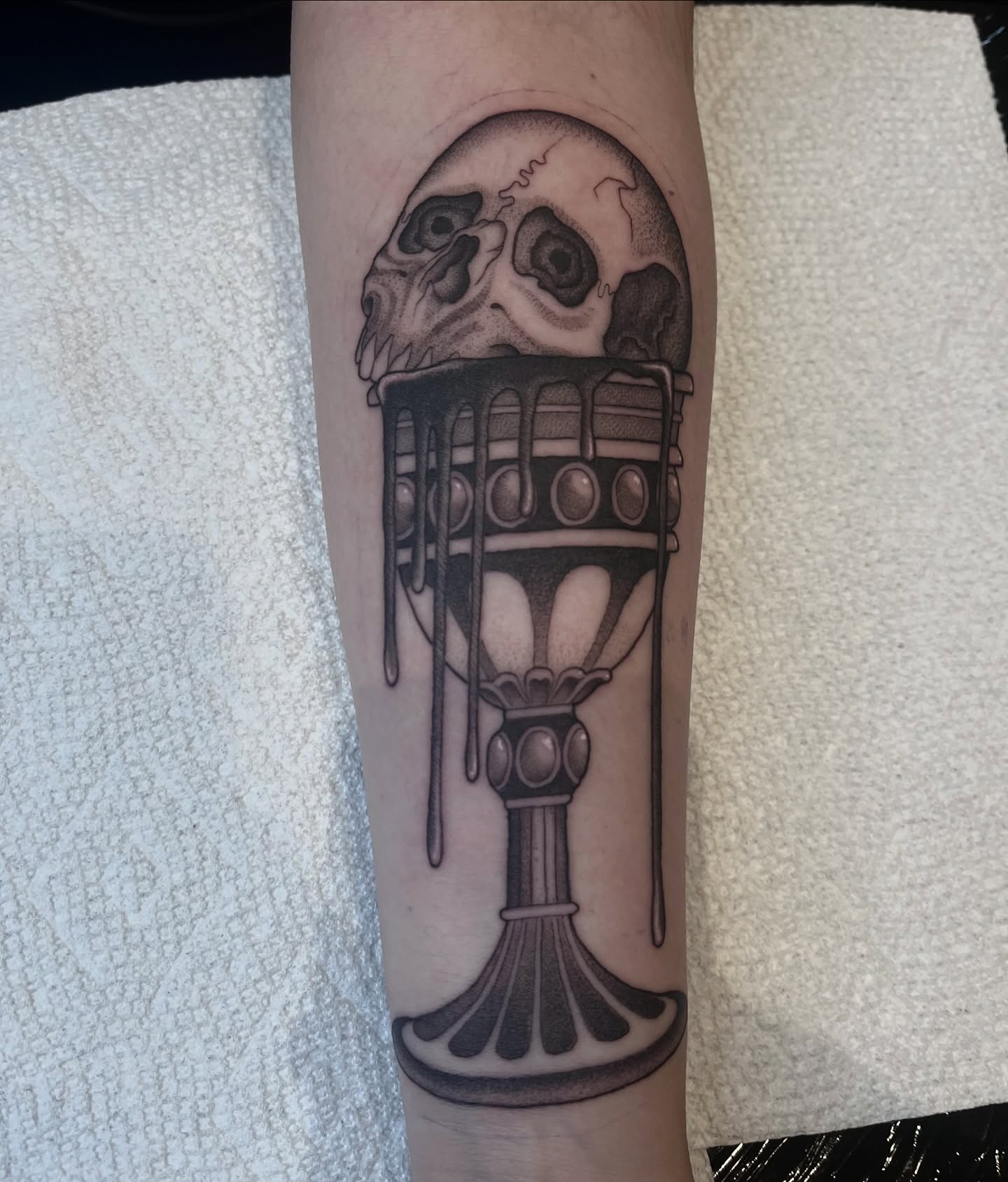 Skull and goblet realism tattoo on the forearm by ๐๐๐๐๐๐๐