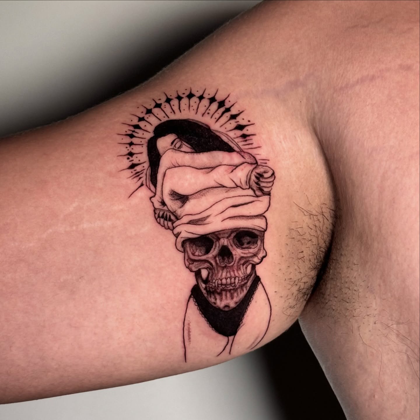 Skull with bandages black and grey tattoo on the forearm by Brisia Cisneros