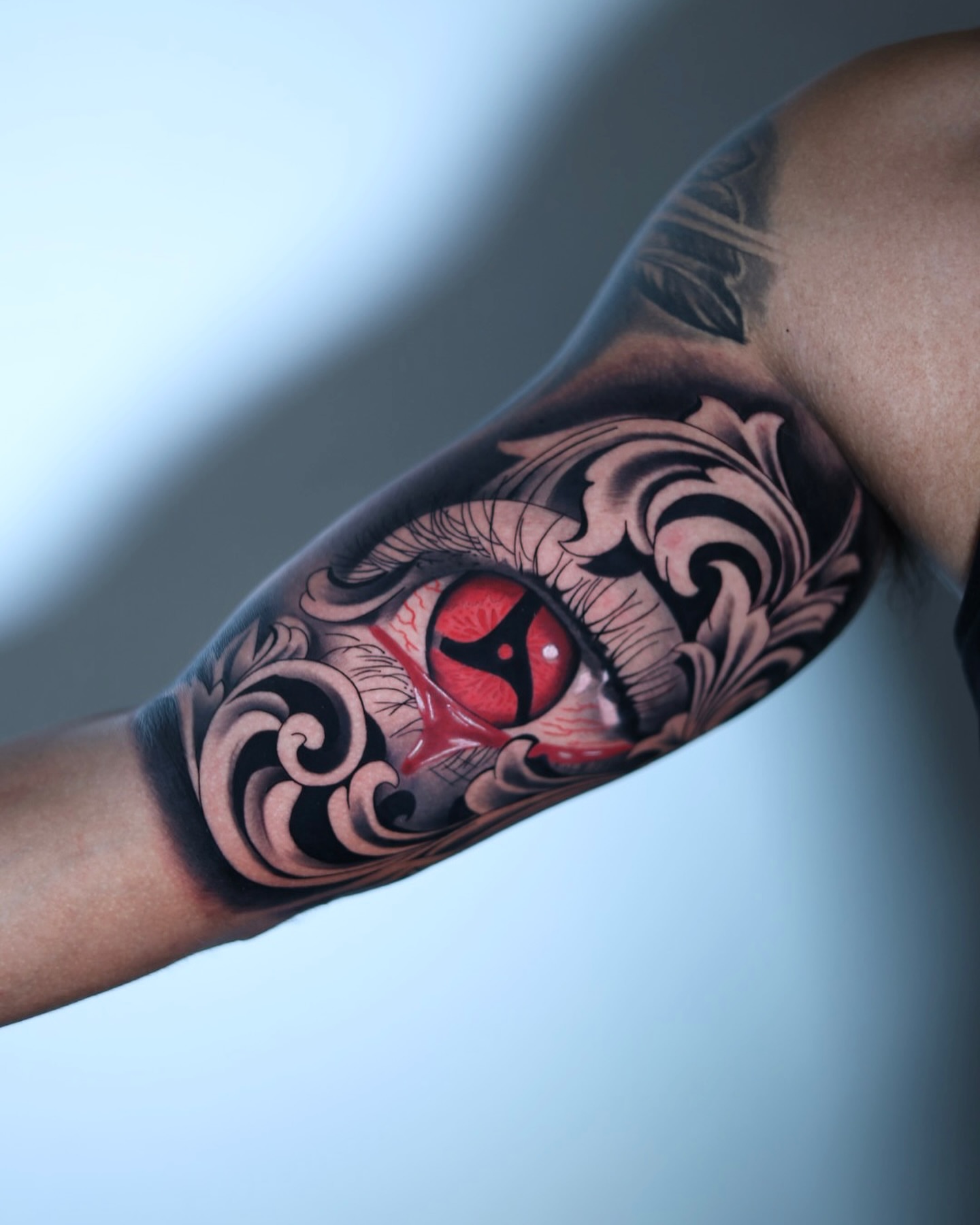 Red eye realism tattoo on the forearm by Tiago Ink