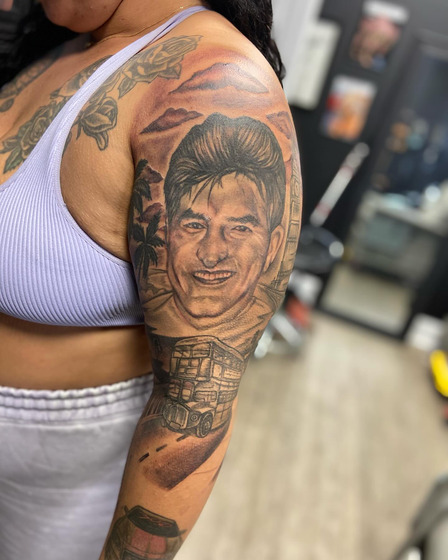 Portrait realism tattoo on the upper arm by Adrian Shan Carr