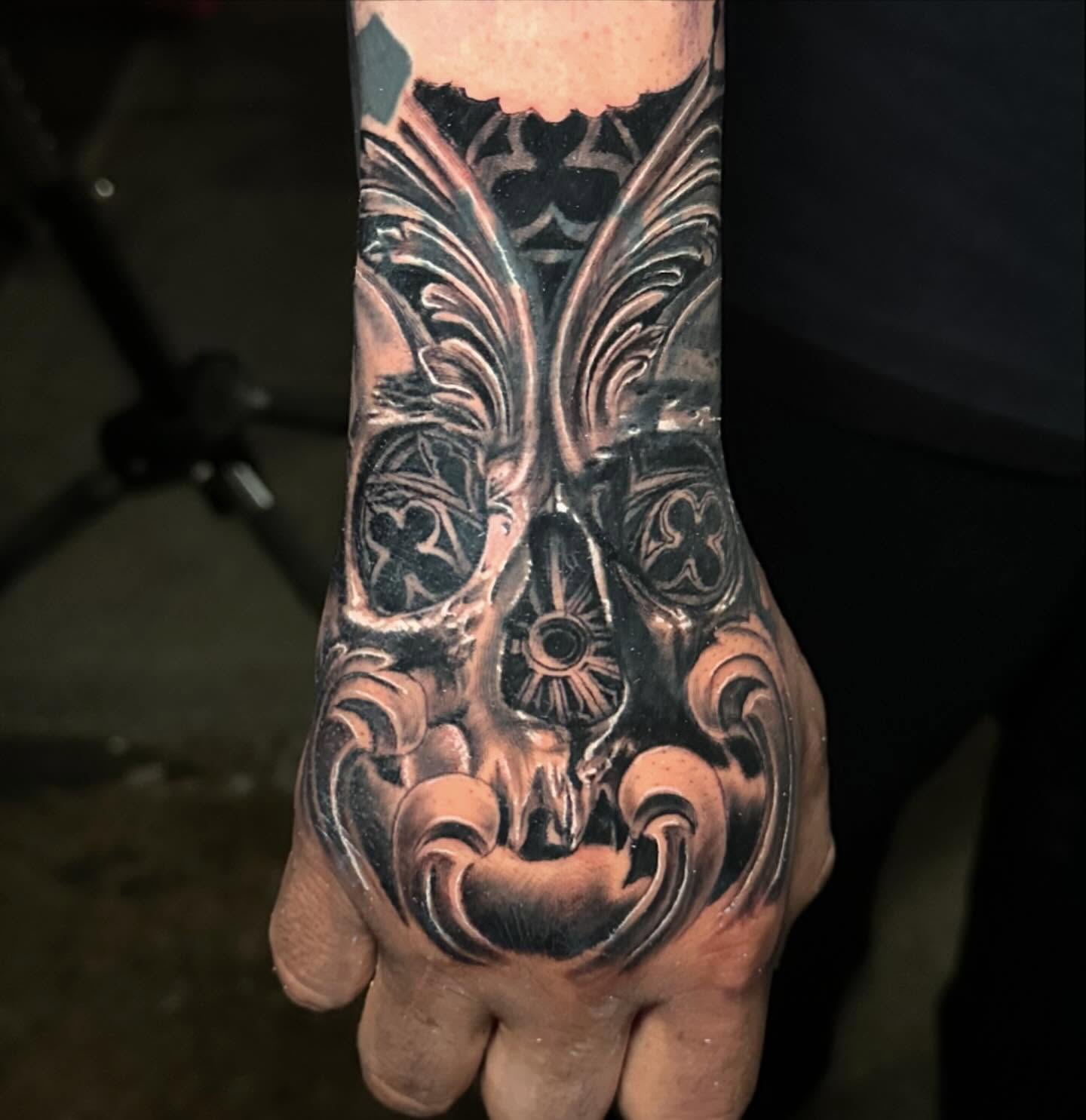 Mask geometric tattoo on the hand by Christian Medina, Sacramento, California
