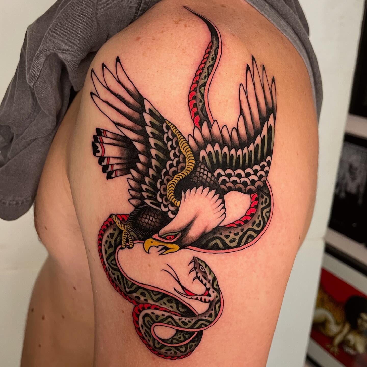 Eagle and snake American traditional tattoo on the shoulder by Niko Mulhearn