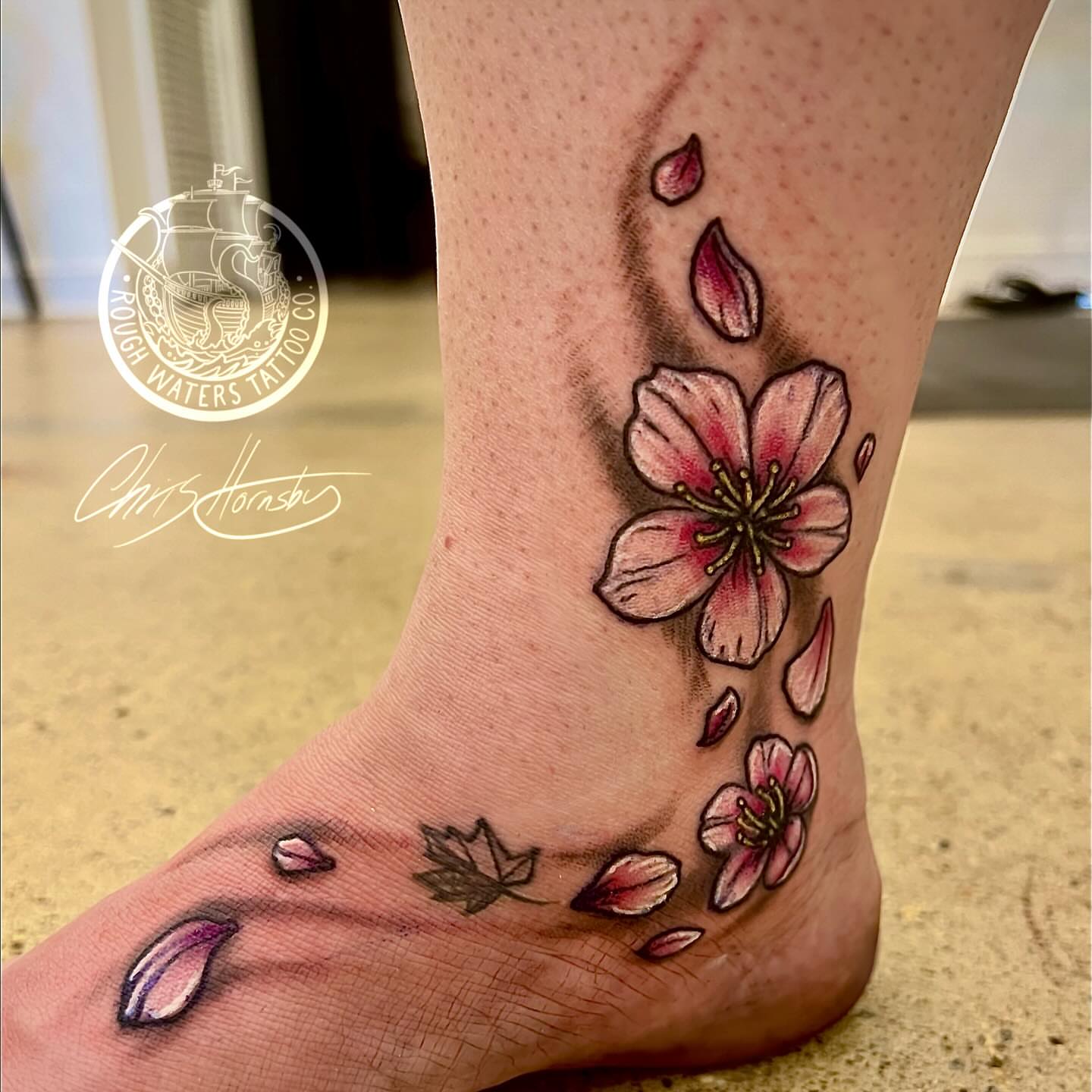Cherry blossoms realism tattoo on the foot by Chris Hornsby