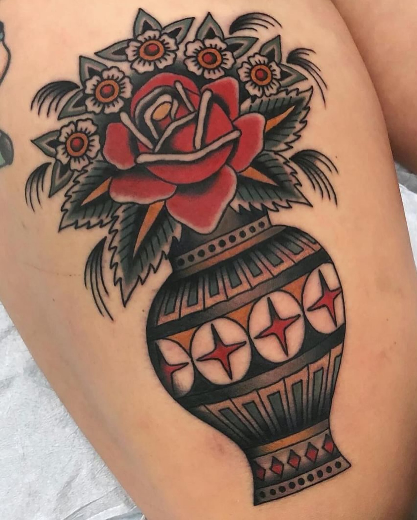 Vase with flowers American traditional tattoo on the thigh by Ben Fiedler