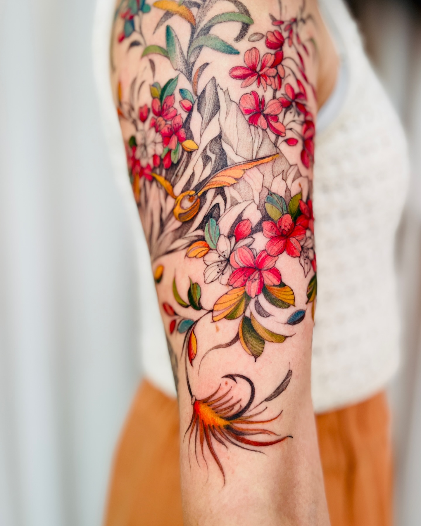 Floral bouquet watercolor tattoo on the forearm by Dung Ngo