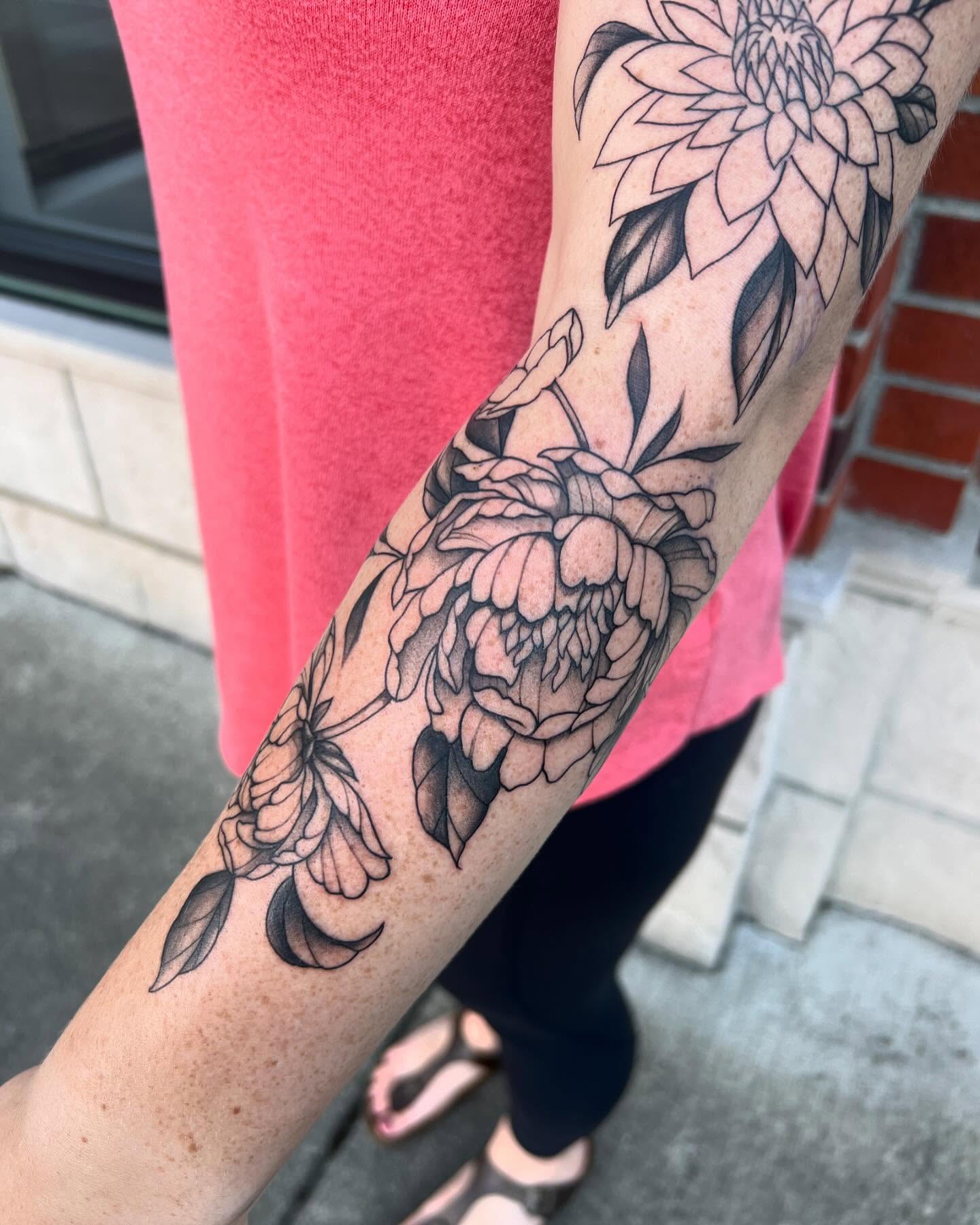 Floral arrangement black and grey tattoo on the forearm by Tasha Venola, Bellingham, Washington