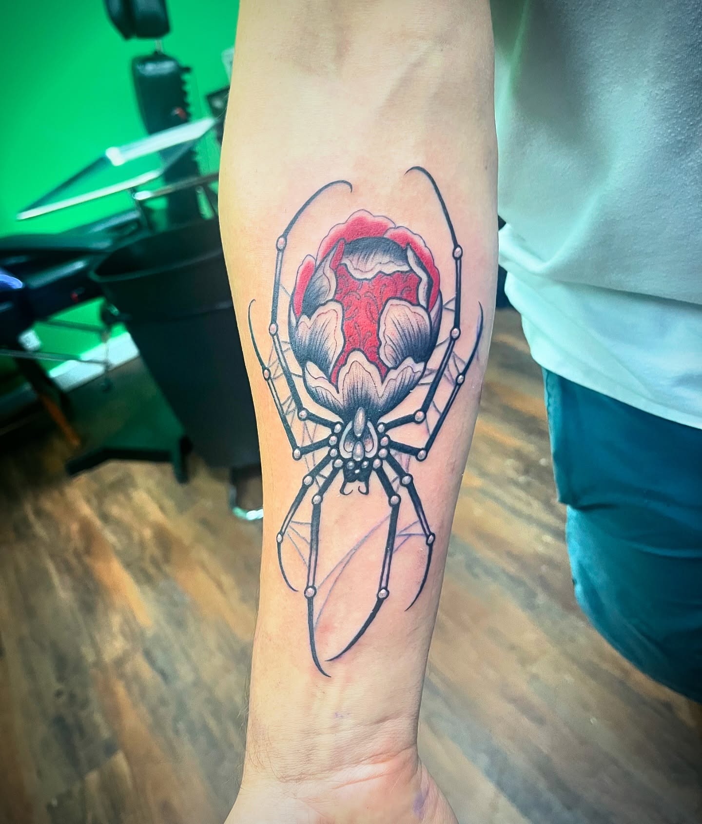 Spider and flower American traditional tattoo on the forearm by Angelique Sanders, Tellico Plains, Tennessee
