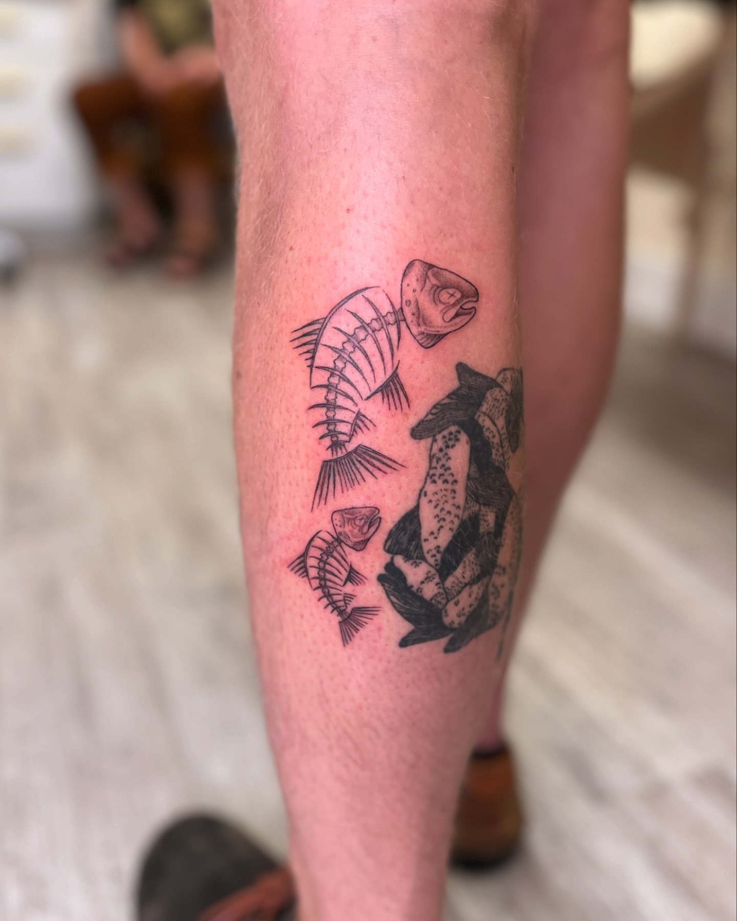 Fish skeleton black and grey tattoo on the leg by Kelsi Hooper, Seattle, Washington