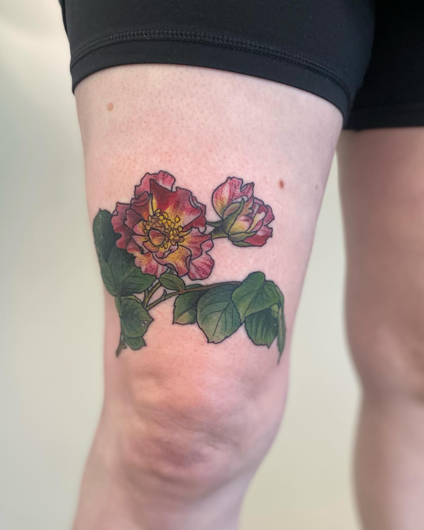 Roses realism tattoo on the thigh by Rusty Indigo