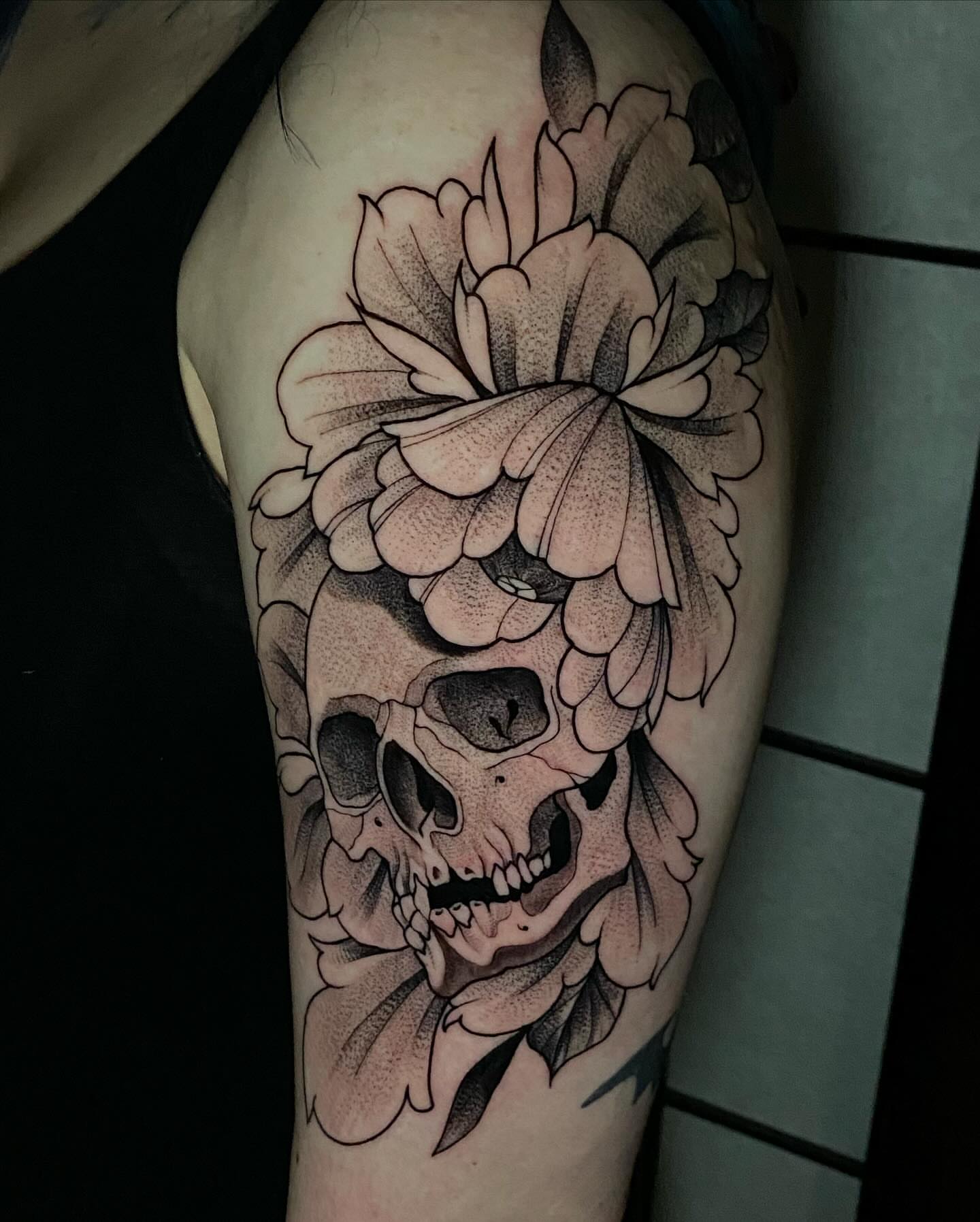 Skull and flowers dotwork tattoo on the thigh by Bruce becerra tattoos