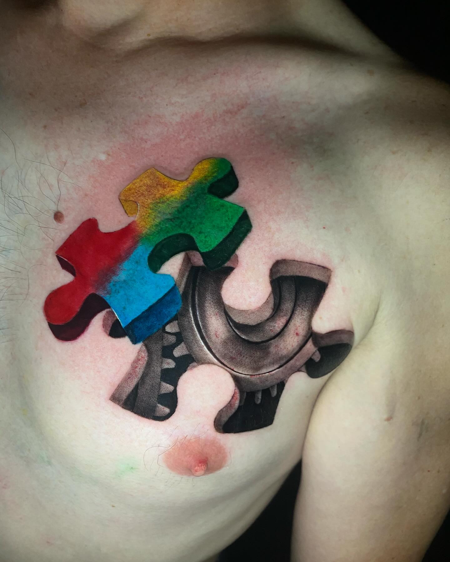 Puzzle piece gear geometric tattoo on the chest by Bruce becerra tattoos