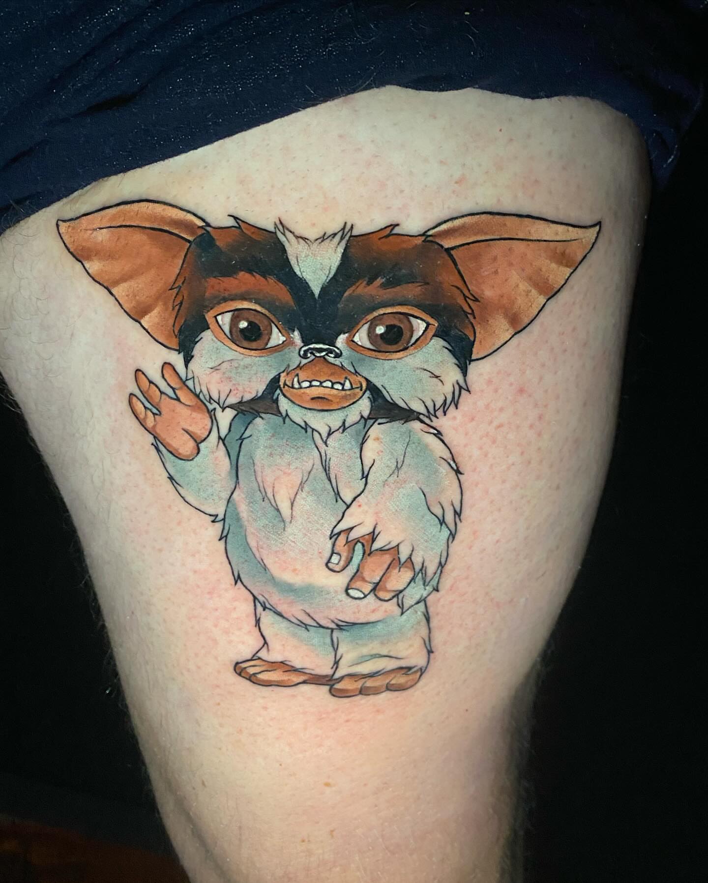 Gremlin watercolor tattoo on the thigh by Bruce becerra tattoos