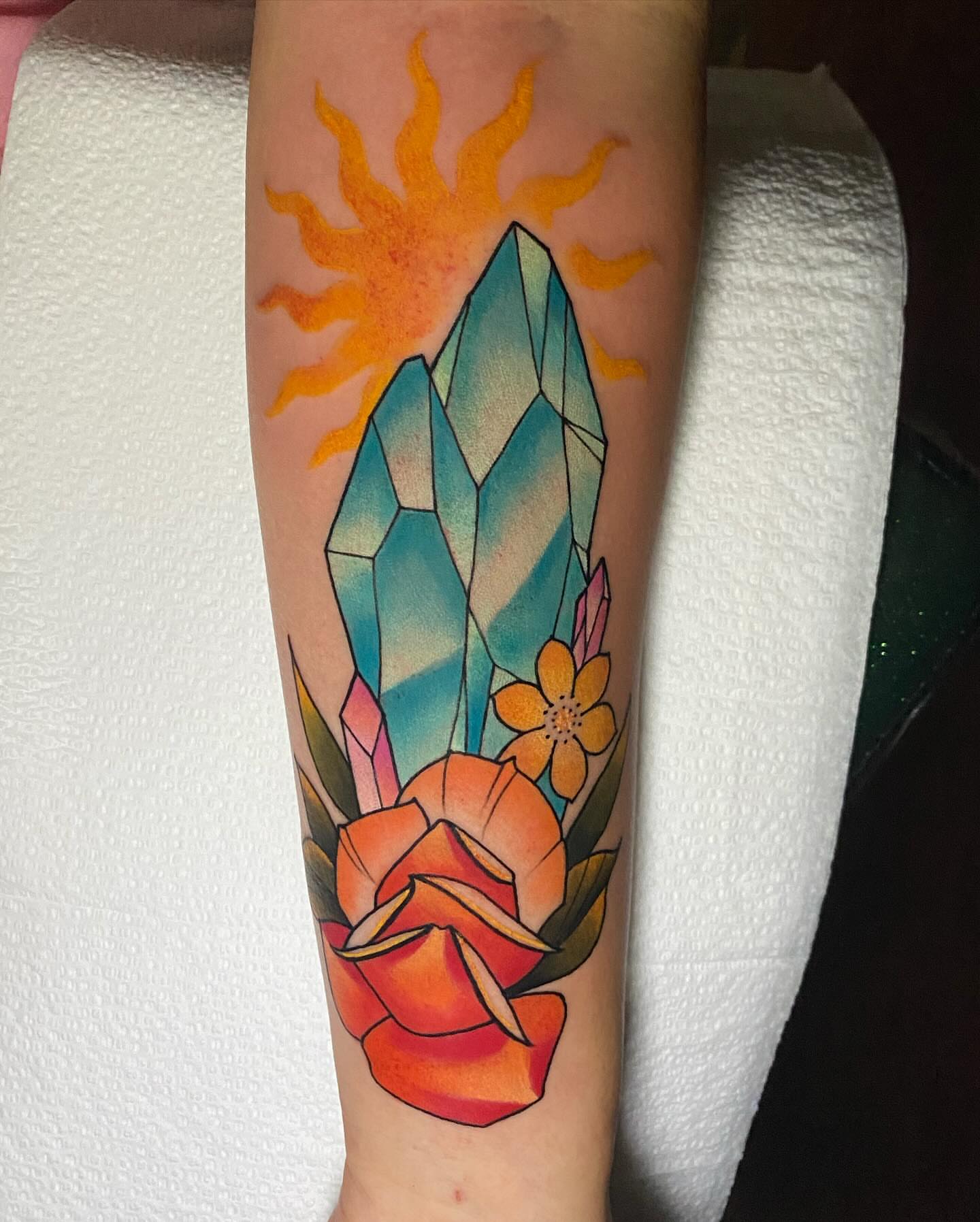 Crystal and sun geometric tattoo on the forearm by Bruce becerra tattoos