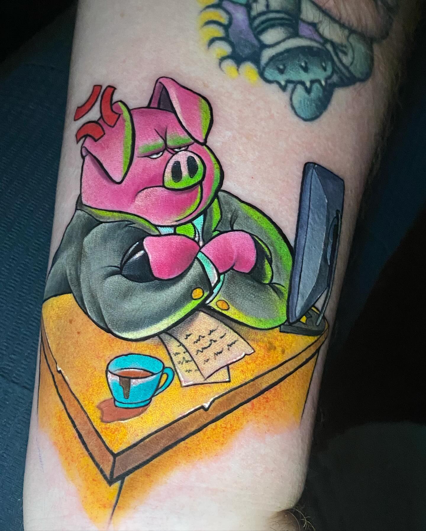 Pig at desk new school tattoo on the forearm by Bruce becerra tattoos