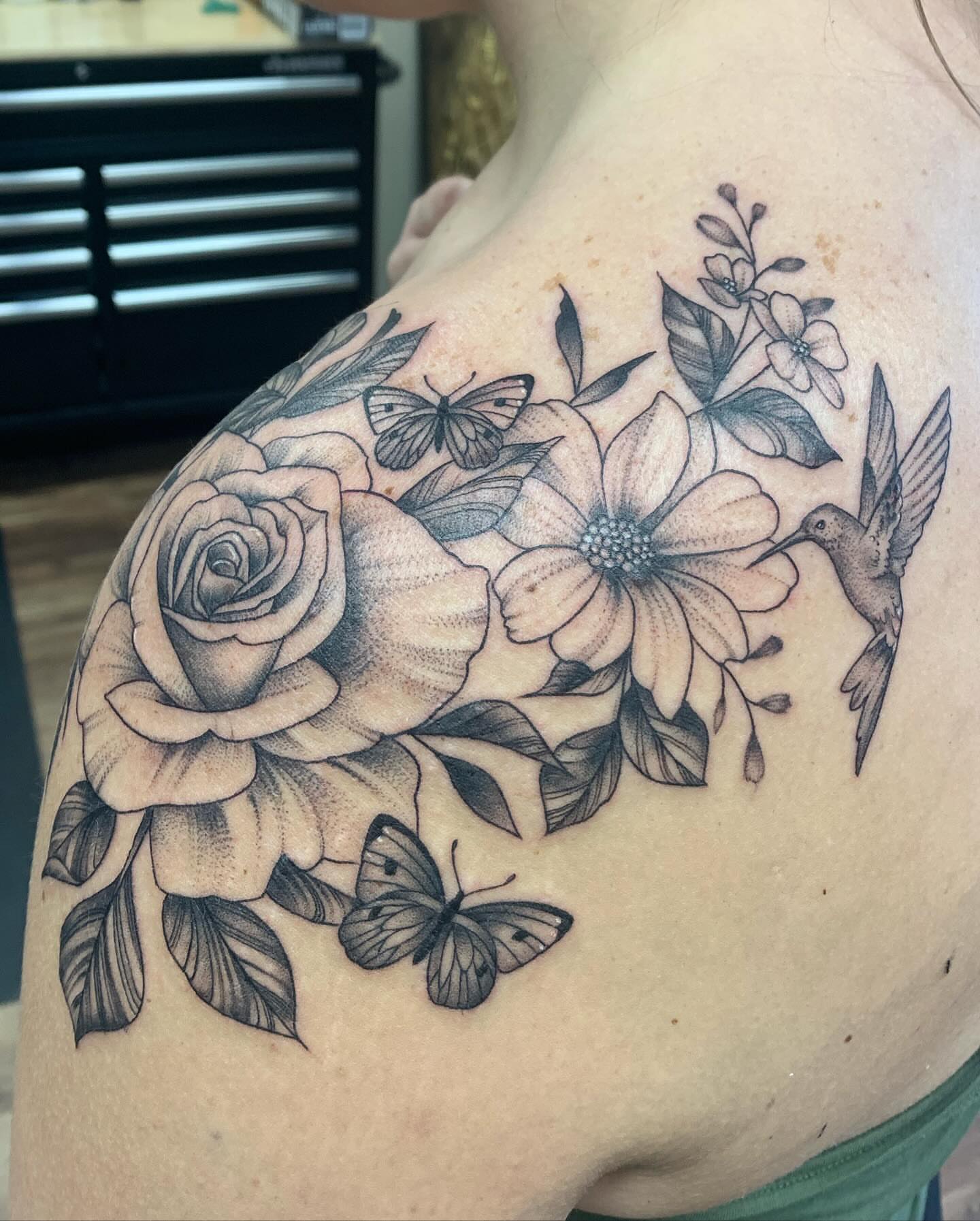 Flowers and butterflies realism tattoo on the shoulder by Brad Sterling