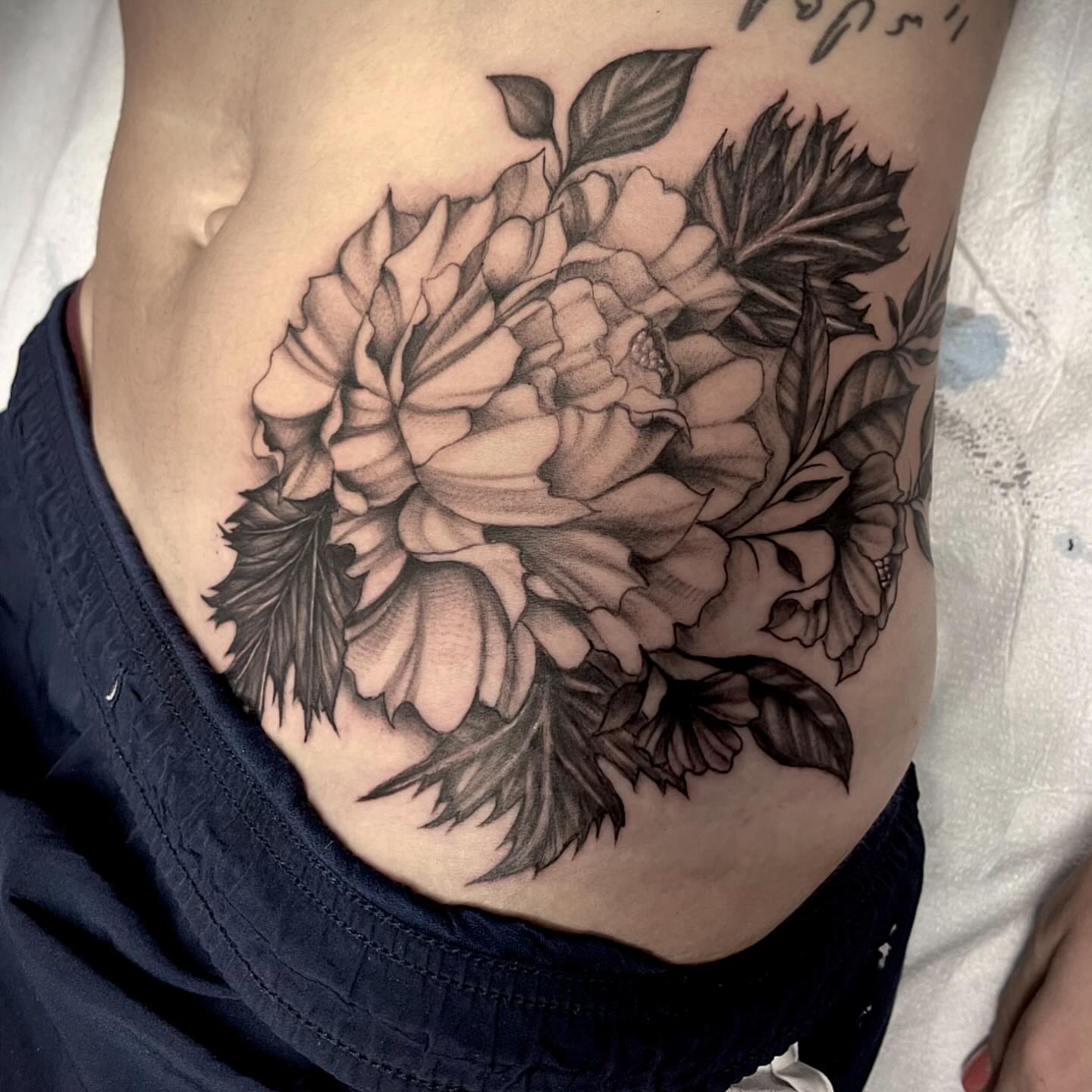 Peony black and grey tattoo on the ribs by Ashly Hutchens, Richmond, Virginia