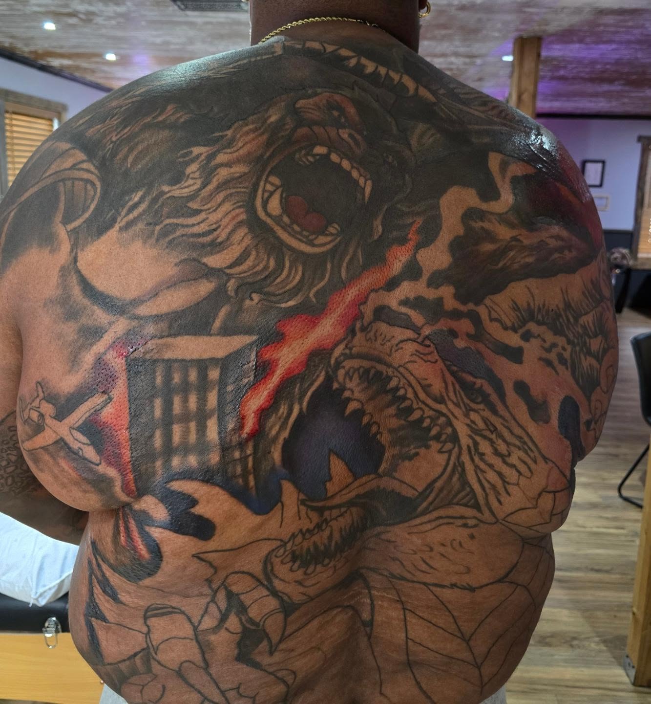 Monster attack dark realism tattoo on the back by Cody Lambert