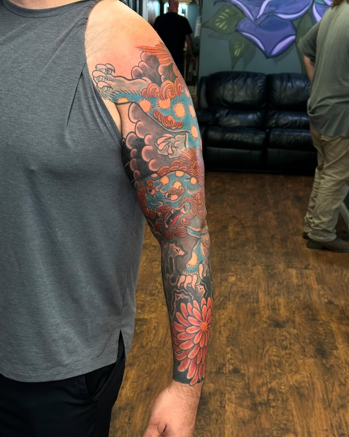 Floral and wave design japanese irezumi tattoo on the upper arm by Jackie