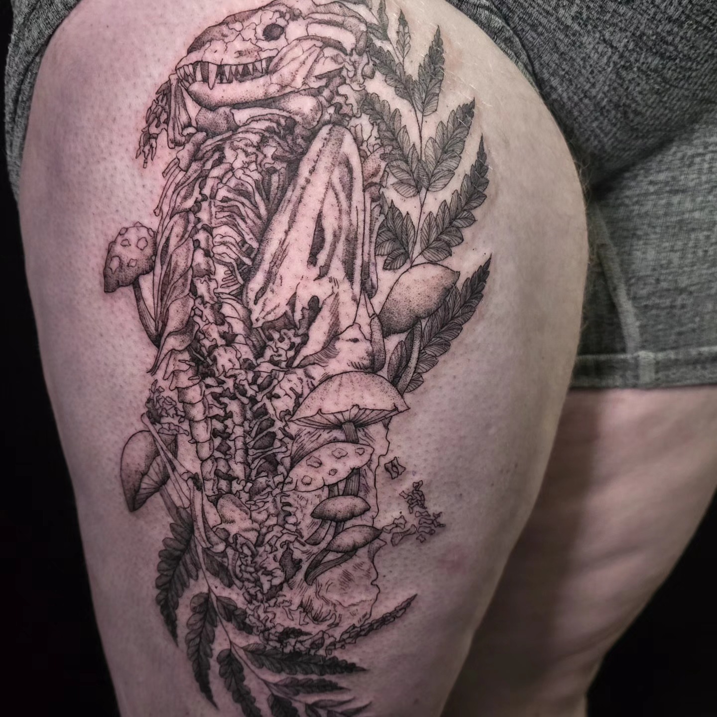 Skeleton and mushrooms realism tattoo on the thigh by Utah Tattoo Artist