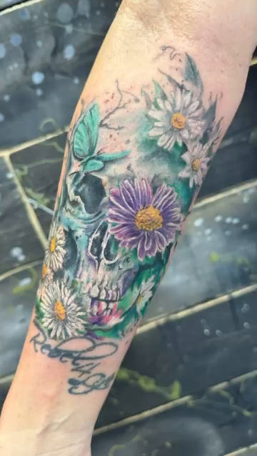 Skull with flowers realism tattoo by Chris Allen Taylor