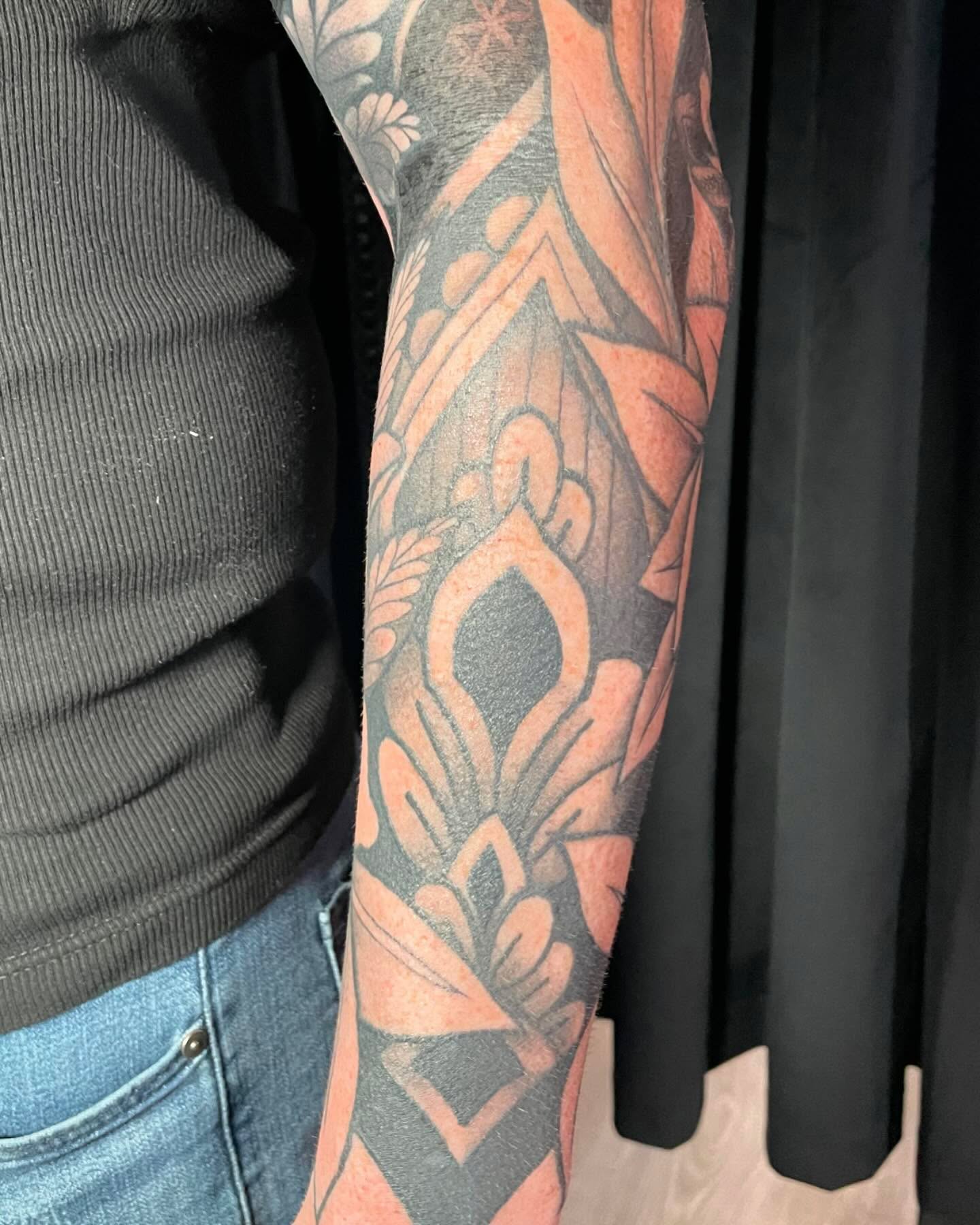 Lotus flower geometric tattoo on the forearm by Tayler Beetison