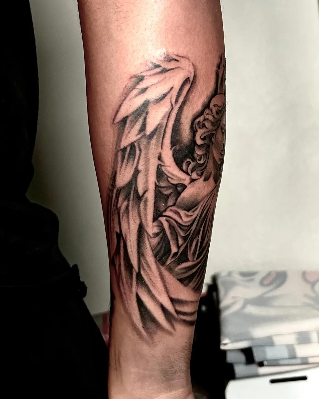 Angel wings realism tattoo on the forearm by Dylan Stevens