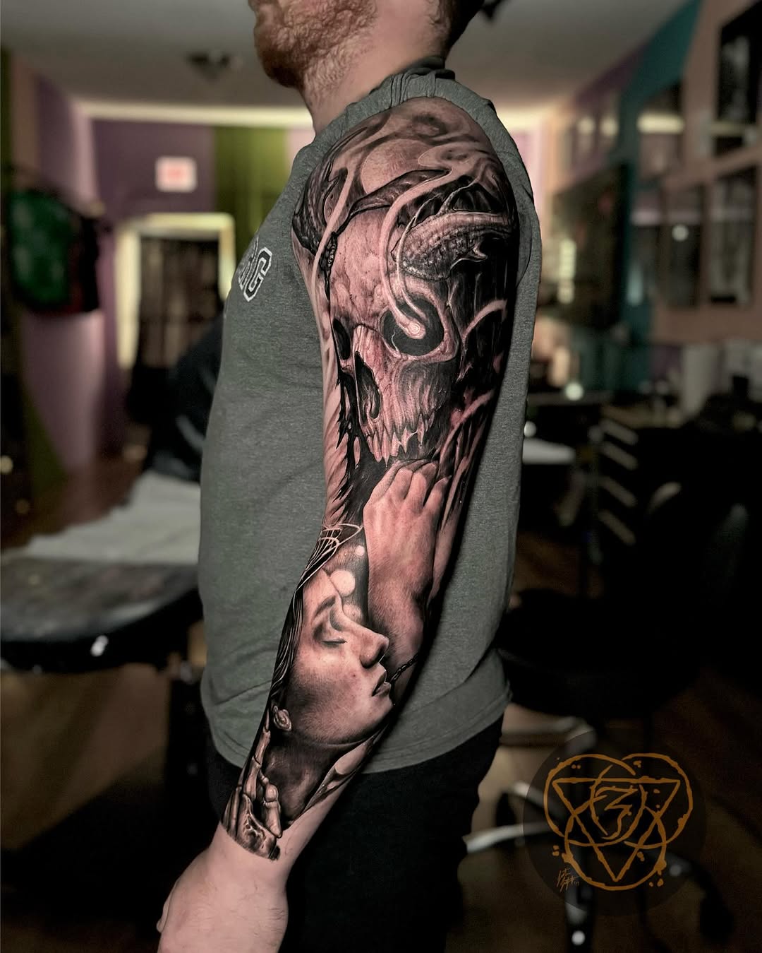 Skull and woman portrait realism tattoo on the upper arm by Justin (iam3) Leifeste