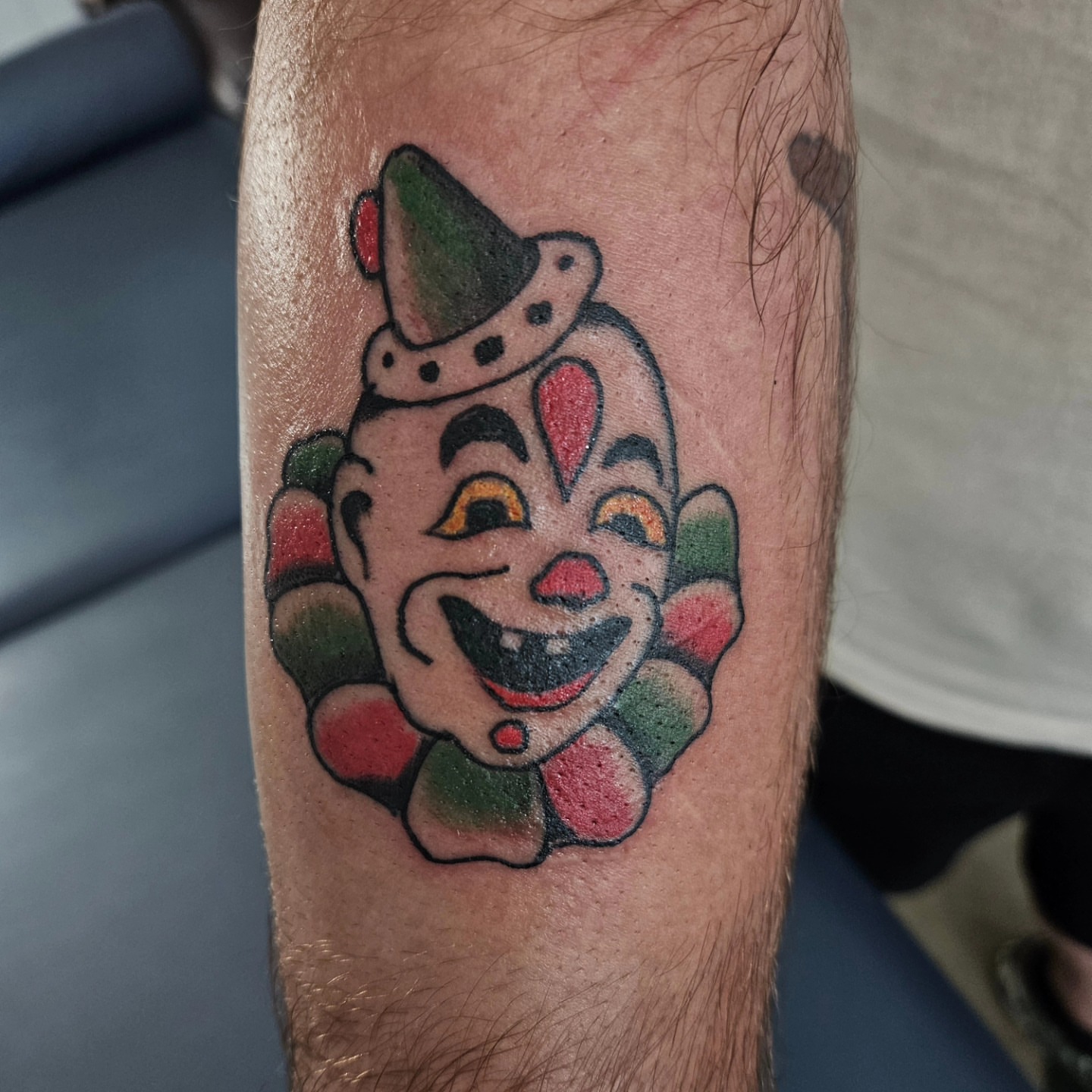 Clown face American traditional tattoo on the forearm by David Nash, Evansville, Indiana