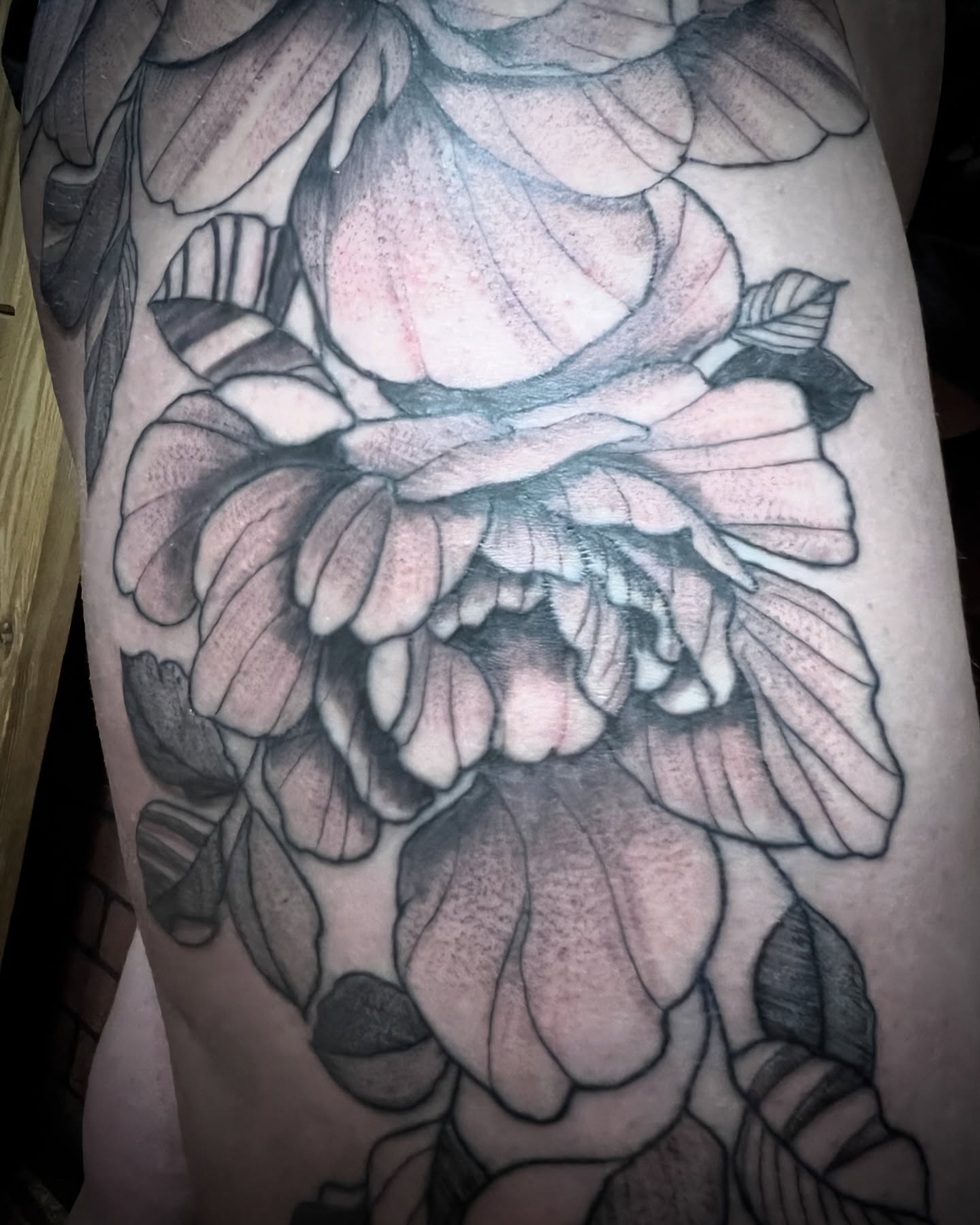 Peony black and grey tattoo on the thigh by Sacramento tattoo
