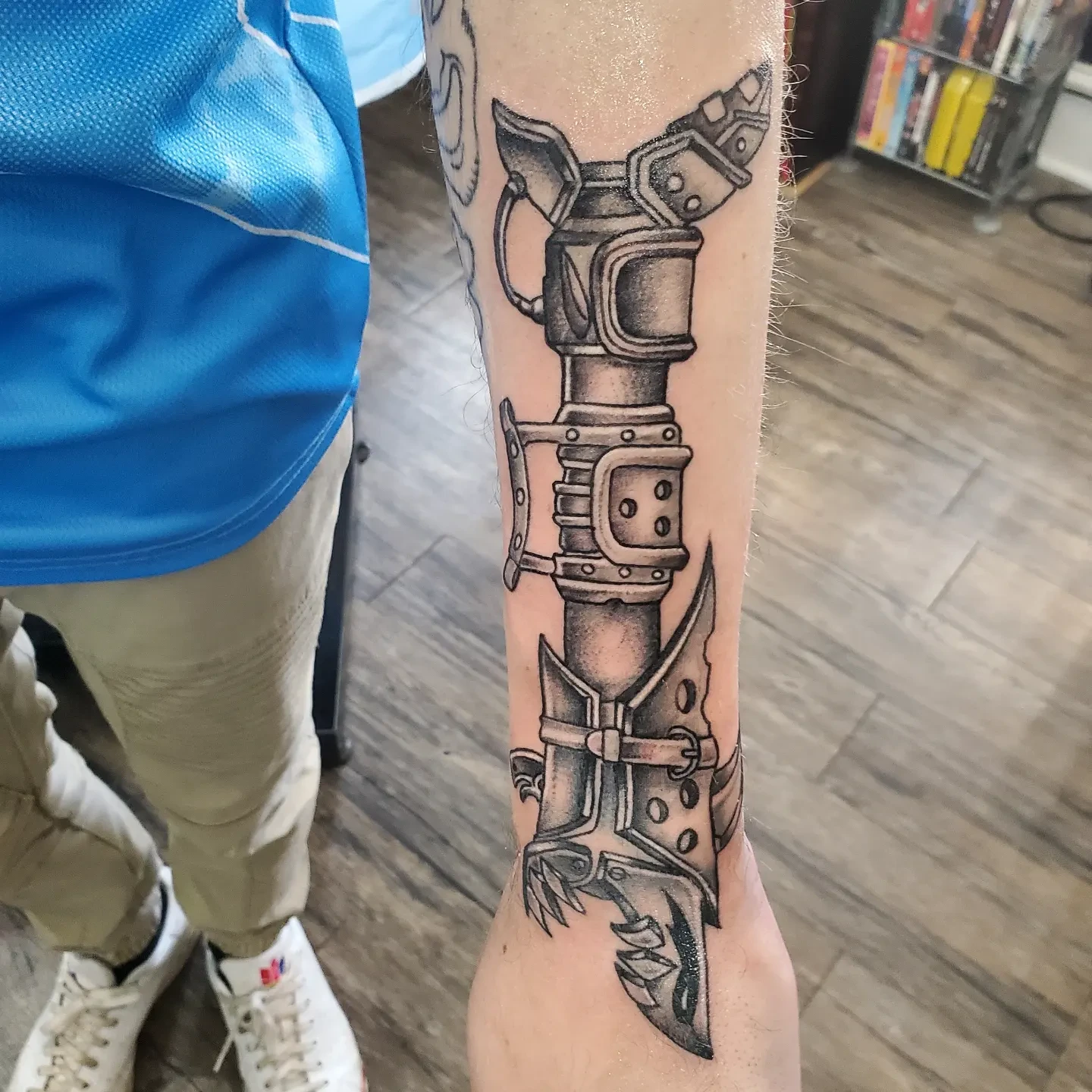 Mechanical gauntlet black and grey tattoo on the forearm by Mike Dell'Erba