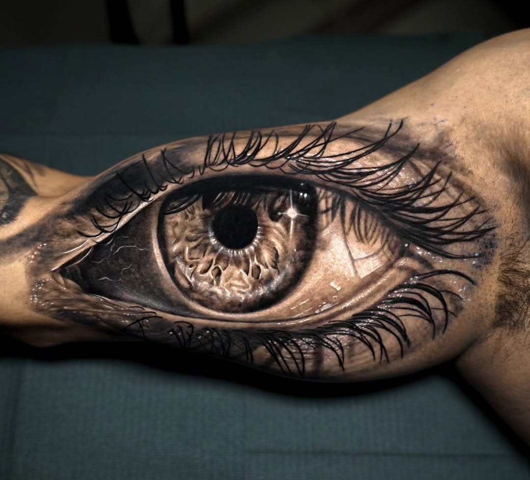 Eye surrealism tattoo on the forearm by Baxtertattoo