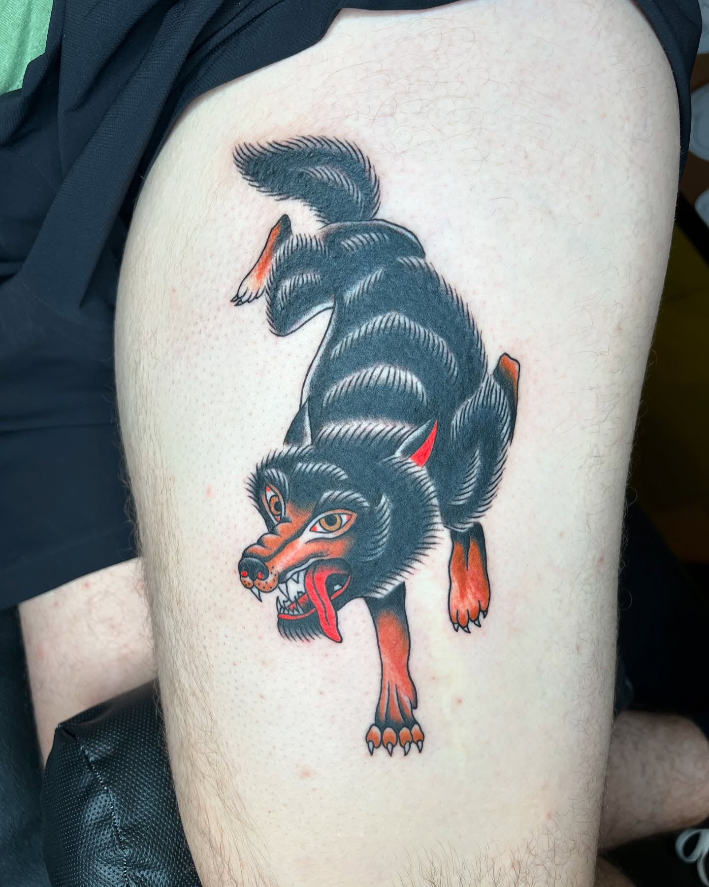 Wolf American traditional tattoo on the thigh by Cory Miller