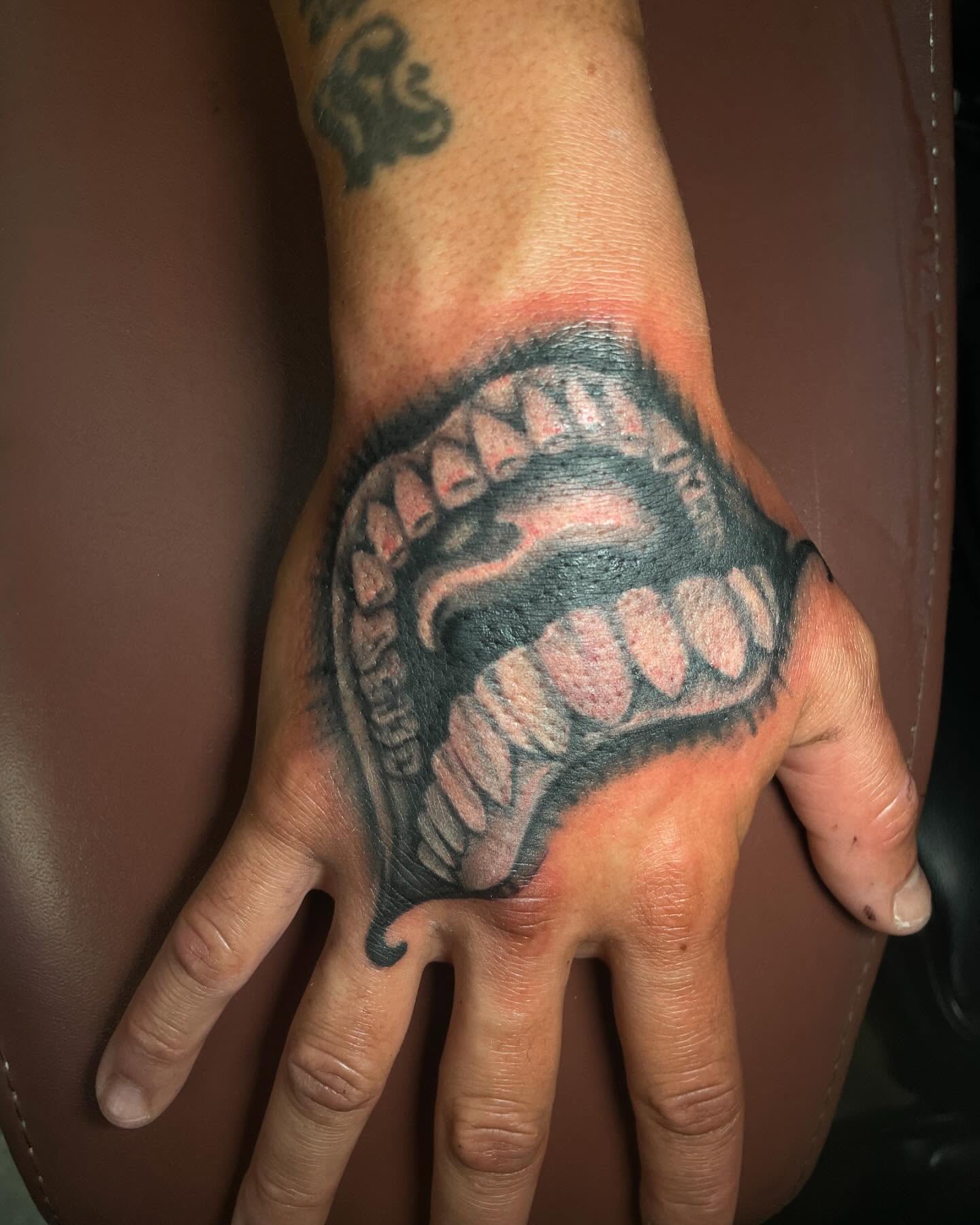 Teeth realism tattoo on the hand by tattoos by lego