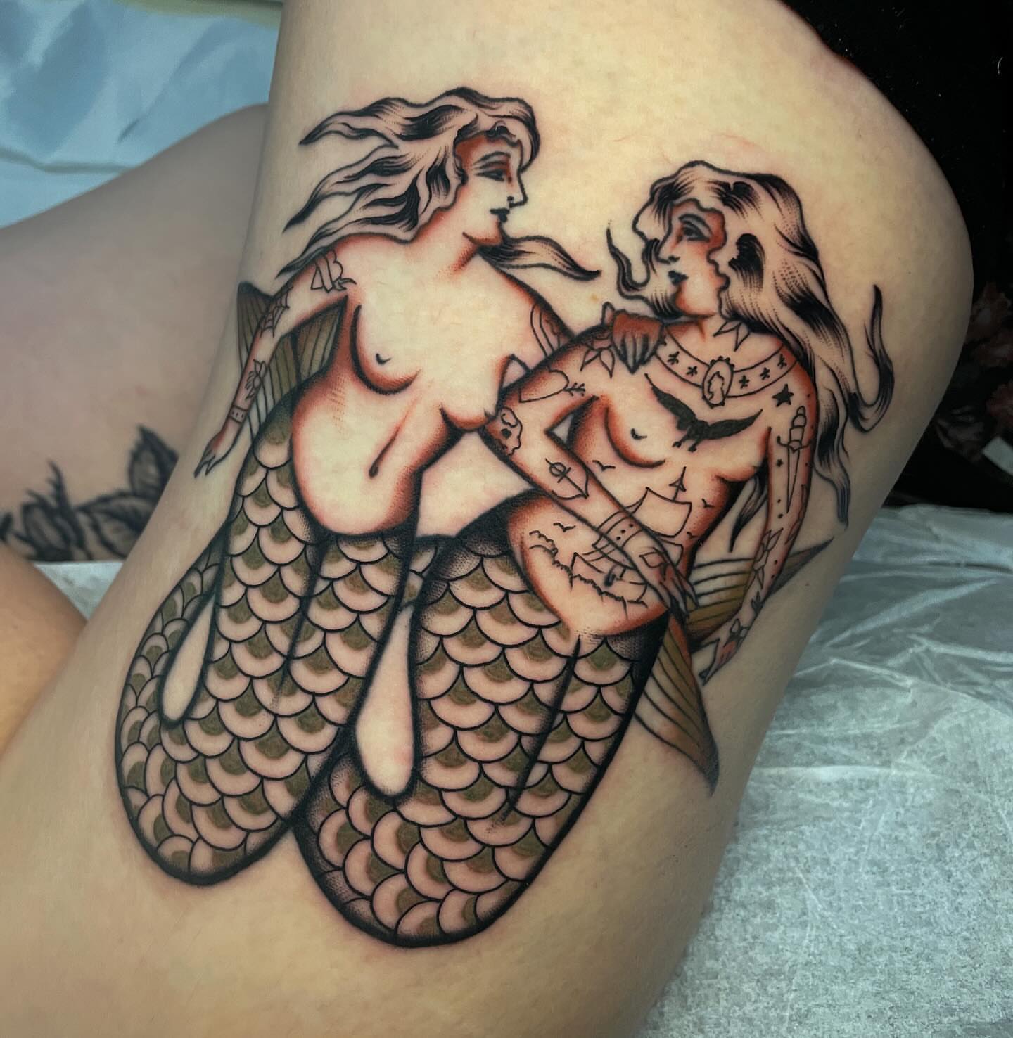 Mermaids American traditional tattoo on the thigh by Toulouse Noble, Portland, Oregon