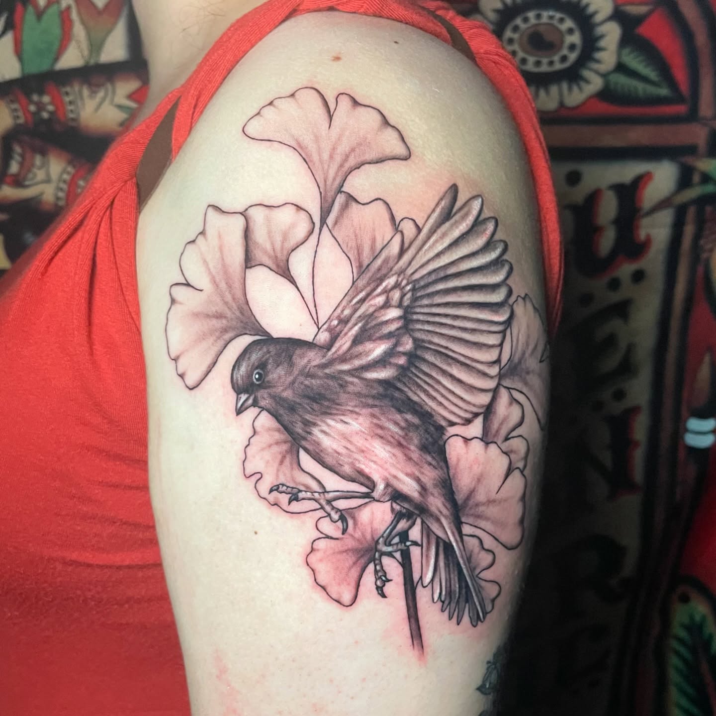 Bird and flower realism tattoo on the shoulder by Alexis Monkiewicz