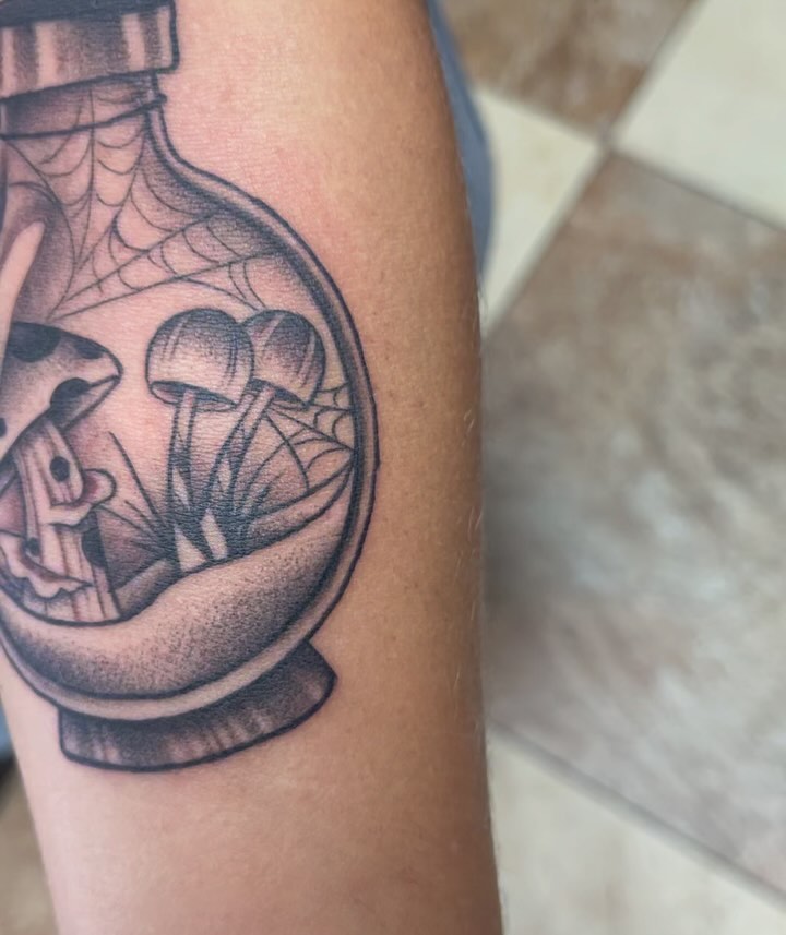 Mushroom bottle black and grey tattoo on the forearm by Alex