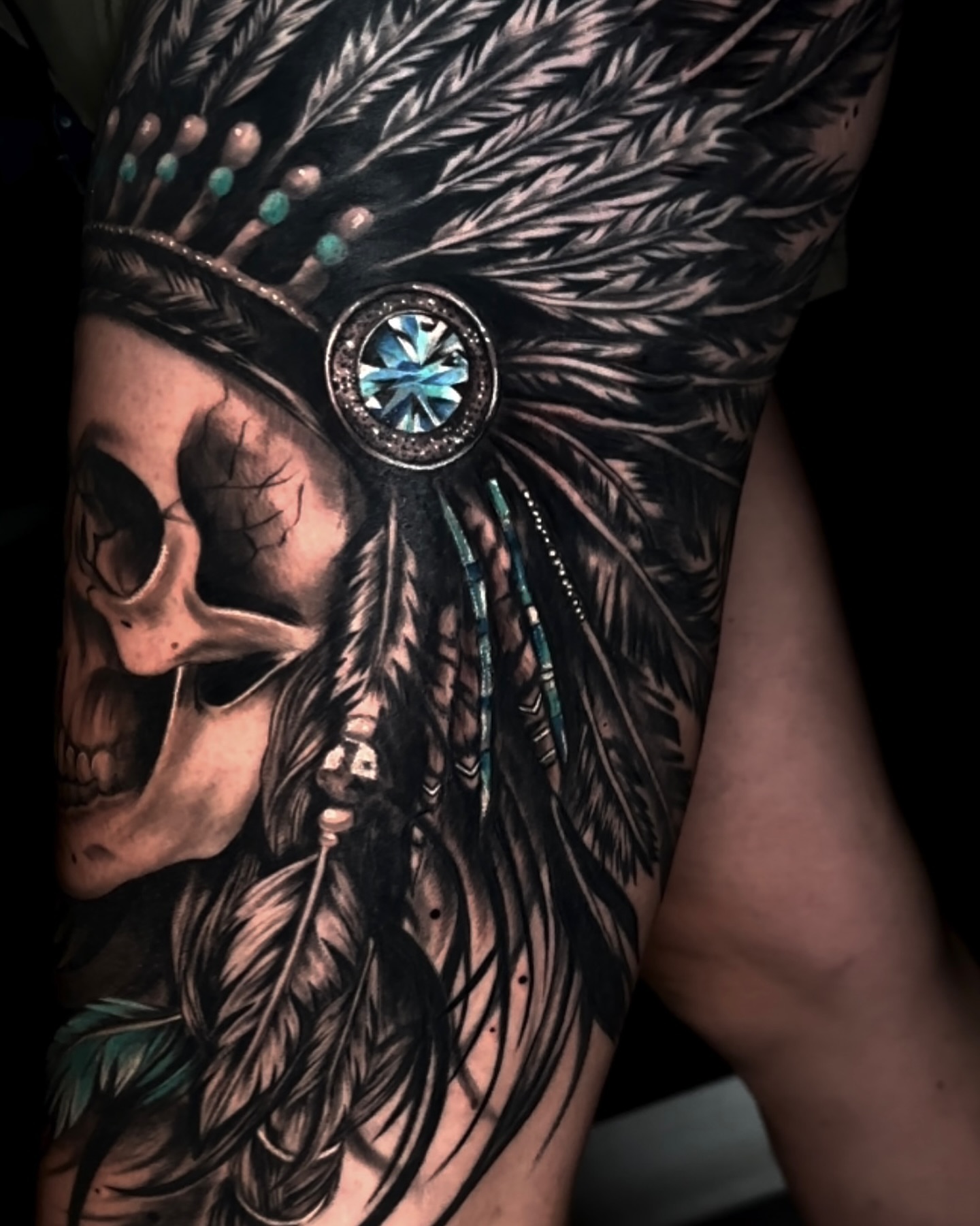 Skull wearing headdress realism tattoo on the thigh by Aris
