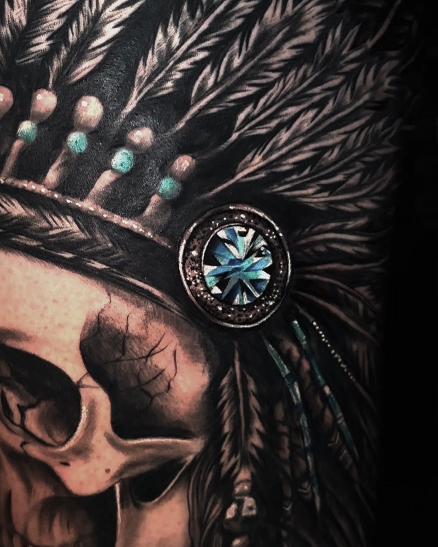 Skull wearing headdress American traditional tattoo on the head by Aris