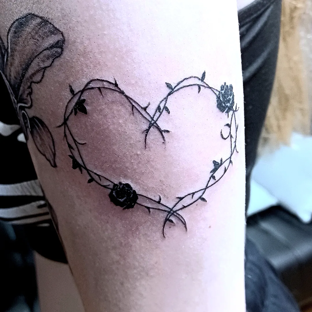 Heart with vines black and grey tattoo on the forearm by hallowed girl tattoo