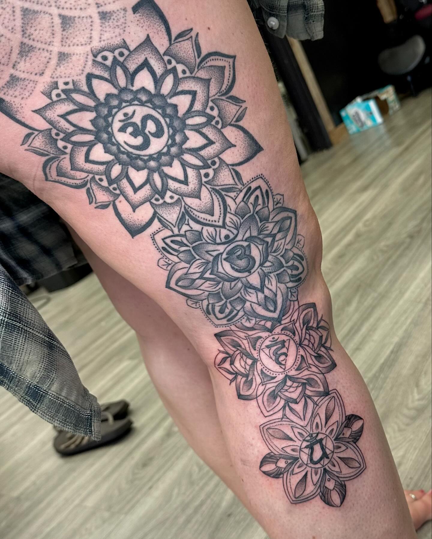 Lotus flowers dotwork tattoo on the thigh by hannah vertal