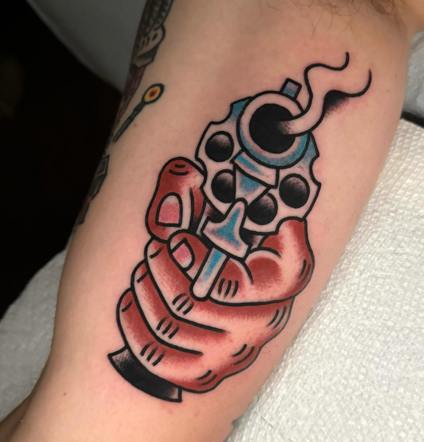 Gun and hand American traditional tattoo on the forearm by James Shepherd, Austin, Texas